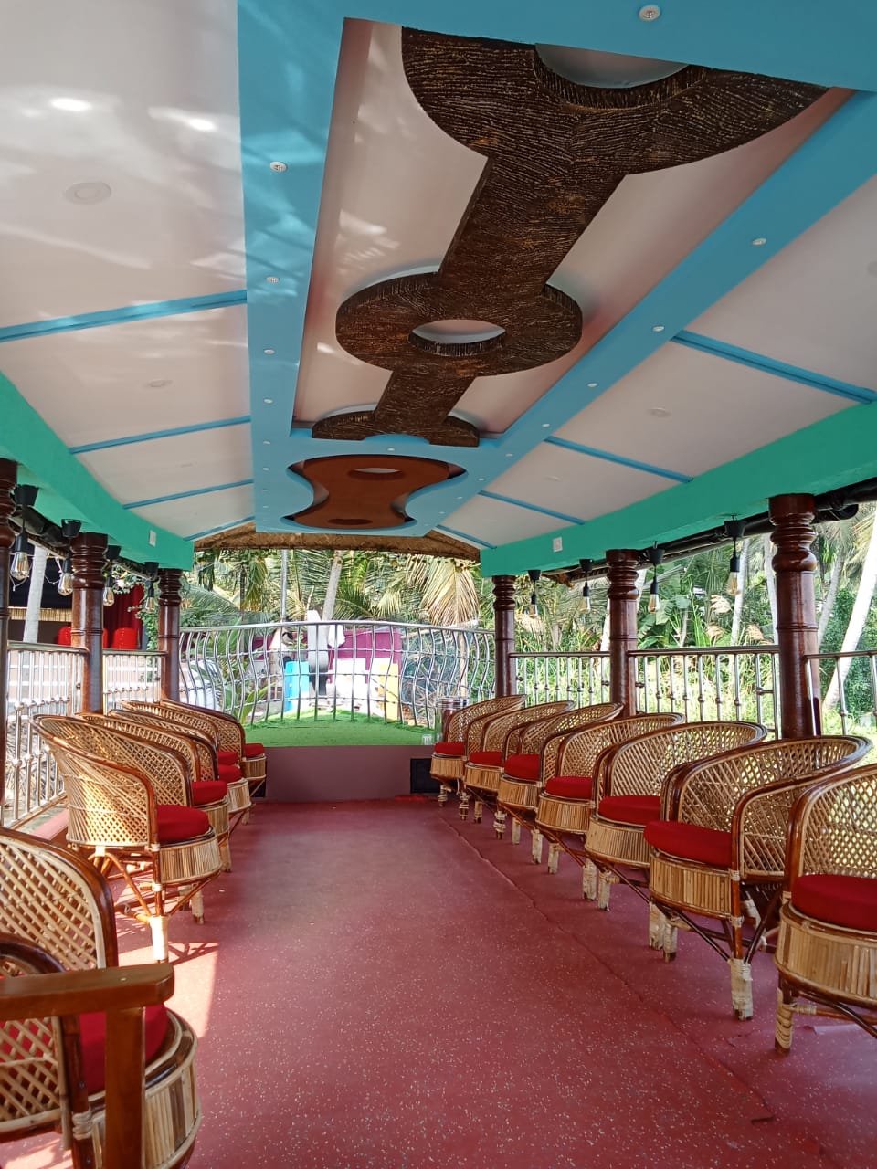 Cushioned seating arrangement inside Lake View Palace houseboat, Akalappuzha