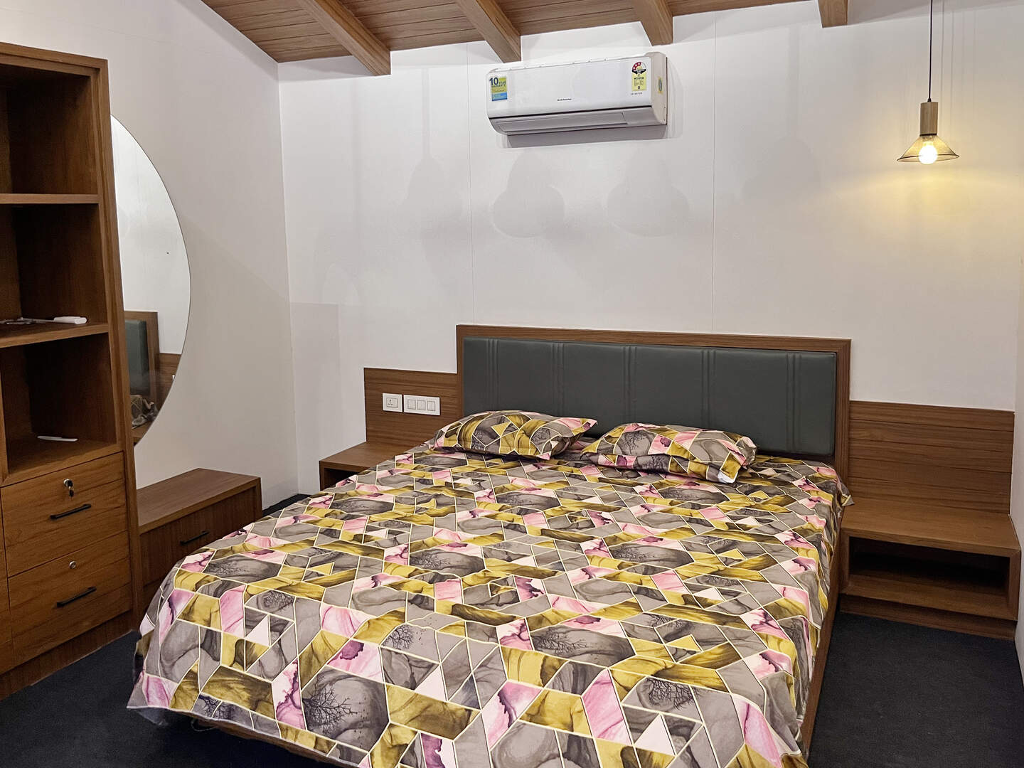 Homestay bed with pillows and side table