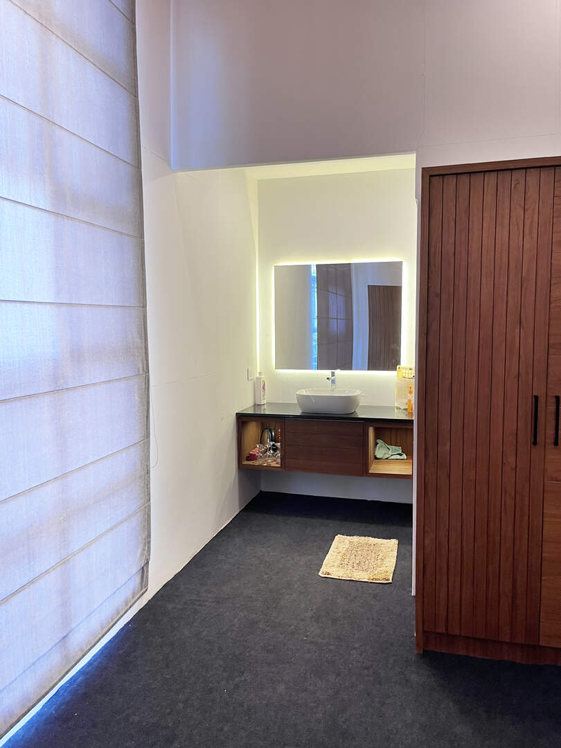 Utility area in homestay room with mirror